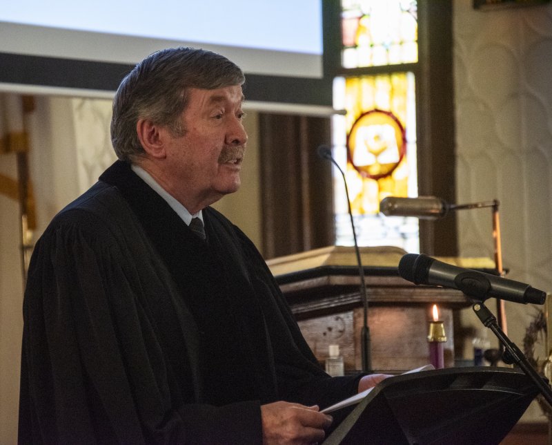 The Rev. William L. Bartholomew, Groome Church associate pastor, reads a passage.